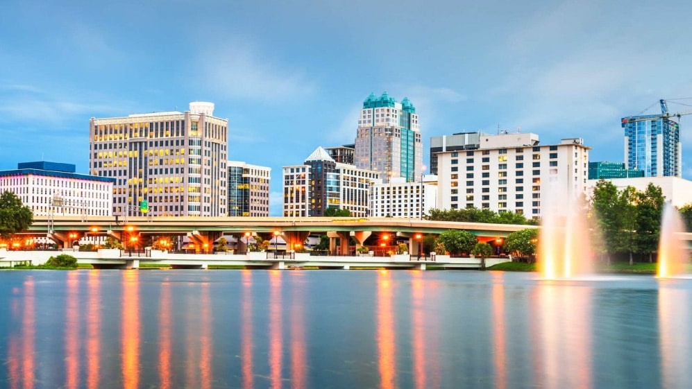 Orlando, Florida, USA aerial cityscape towards Lake Eola at dusk.