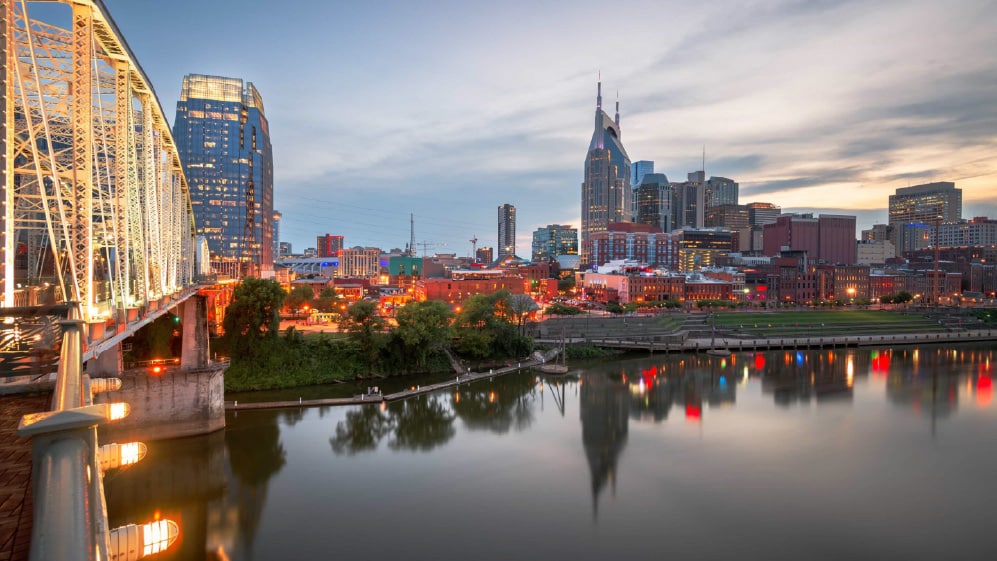 Nashville, Tennessee, USA downtown city skyline at dusk on the Cumberland River.
